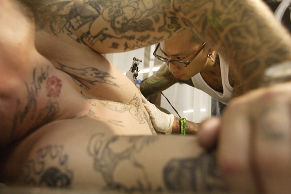 Detail of the head of a tattoo artist is seen at the Body Art Expo