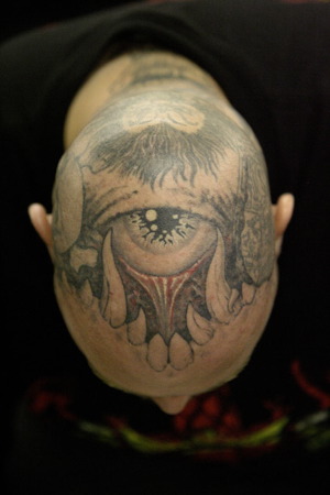 Detail of the head of a tattoo artist is seen at the Body Art Expo